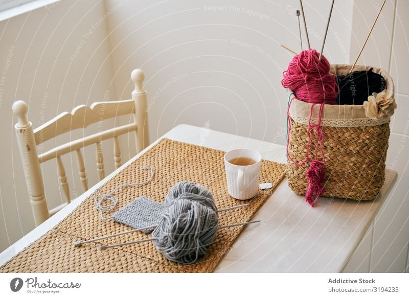 Mug of tea near knitting supplies Knit yarn The Needles Tea Table Cozy Room Basket Leisure and hobbies Warmth Drinking Beverage Hot brewed Supplies tools