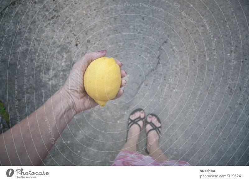 vitamin C Lemon Fruit Citrus fruits Sour Yellow Vitamin C Healthy Healthy Eating Lemon juice Woman feminine feet Flip-flops Stand Street Asphalt Summer Hand