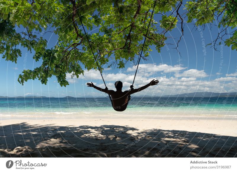 Tourist relaxing on beautiful tropical island Relaxation Tropical Island Beautiful admiring traveller Swing Resting Sand Beach Vacation & Travel Resort