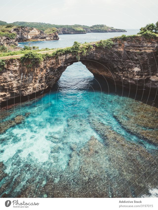 Amazing blue lagoon with cliff archway Lagoon Cliff Arch Landscape Blue Turquoise Bali Formation Tropical Natural Vacation & Travel Nature Water seaside Bay