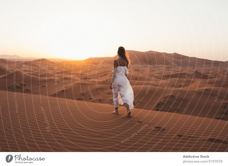 Woman in white dress walking in desert Desert Sunset Sand Morocco Nature Summer Remote Vacation & Travel flying hair Peace Freedom Modern Barefoot Vantage point