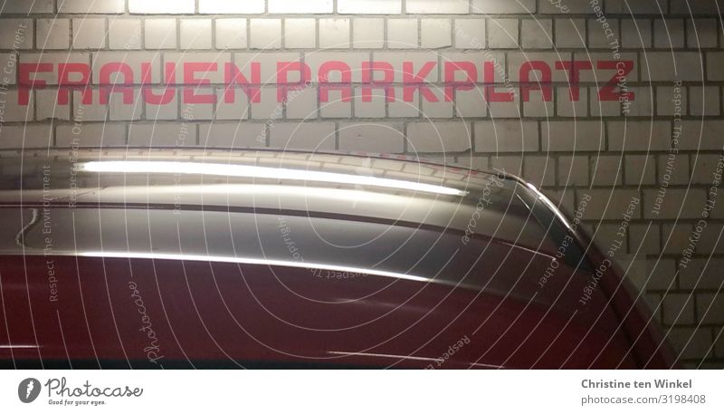 The word "women's parking space" on a wall in a parking garage Parking garage Wall (barrier) Wall (building) Car Characters Signs and labeling Authentic