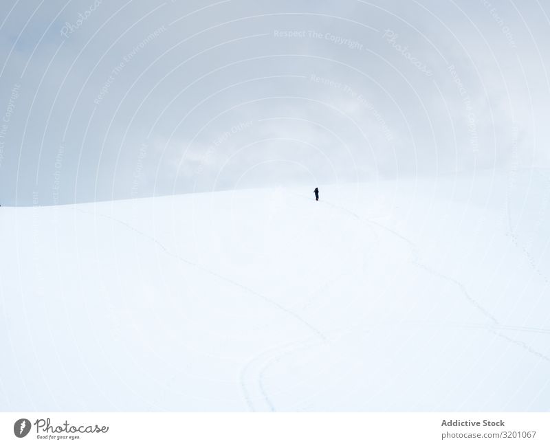 Unrecognizable lonely traveler walking on snowy hill Loneliness Inspiration Snow Minimalistic Hill Landscape Nature Mountain Tourism Adventure Cold Tourist