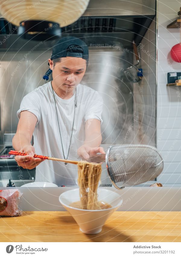 Asian male cooking ramen in cafe Man Cook Food Noodles Japanese Dish Restaurant occupation chef Café Kitchen Work and employment Profession Youth (Young adults)