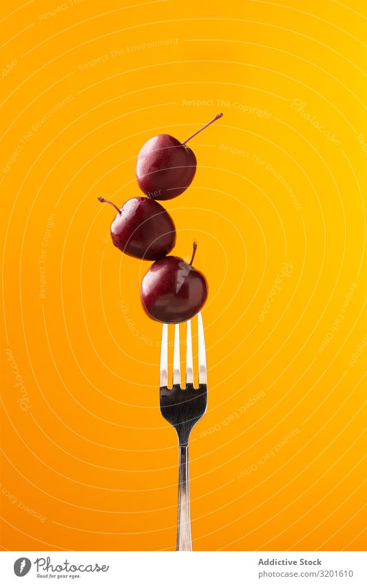 Composition of ripe red cherries on fork Cherry Fork composition Mature Red Tasty Juicy Bright Yellow Food Meal Delicious Sweet Fresh Dessert appetizing Fruit