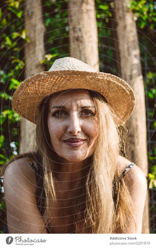 Smiling woman in straw hat looking away Woman Street Summer Vacation & Travel Contentment contemplate Adults Straw hat Relaxation Beautiful Joy Happy Tourism