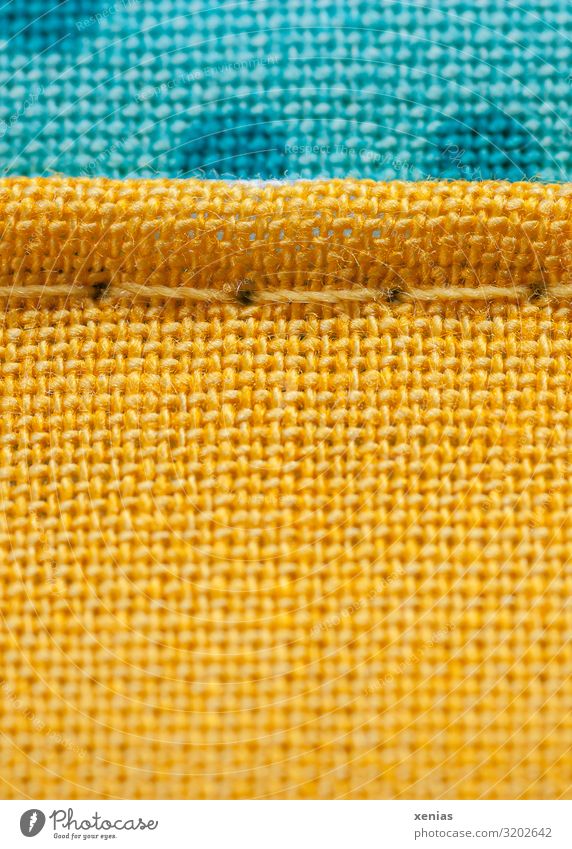 Macro shot: yellow and blue fabric with seam Clothing Stitching Linen Sewing thread Textiles Blue Yellow Structures and shapes Studio shot Detail