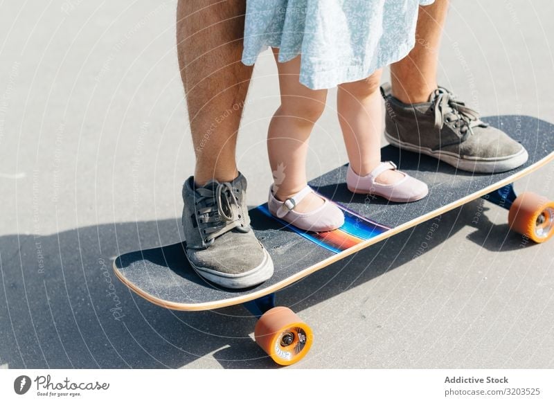 Crop father with infant daughter on skateboard Man Daughter Skateboard Family & Relations Father Small Child Dress Cute Ride Parents Sports Street Girl