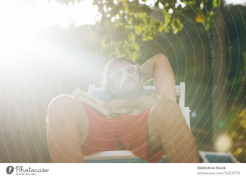 Man chilling on deckchair in sunshine Deckchair Vacation & Travel Summer Thailand Sunlight Book Relaxation Leisure and hobbies sunbed Swimsuit Heat Resort