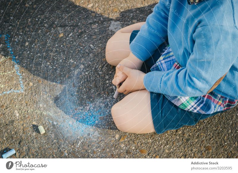 Child sitting on asphalt with colorful chalks Street Drawing Playful Freedom Chalk Creativity Asphalt Joy Infancy Multicoloured Happy Happiness
