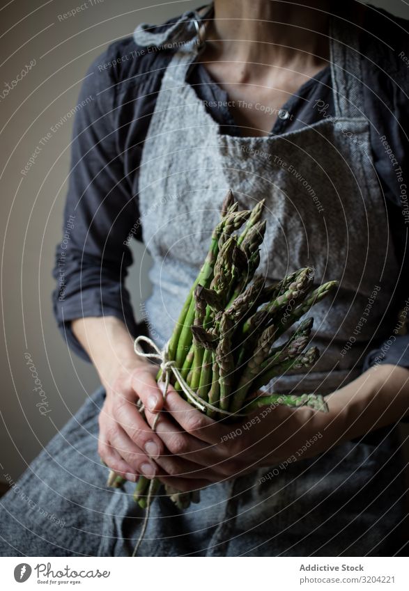 Faceless woman holding bundle of green asparagus Woman Asparagus Rustic Green Bundle Hand Hold Organic Diet Food Natural Nutrition Raw Ingredients