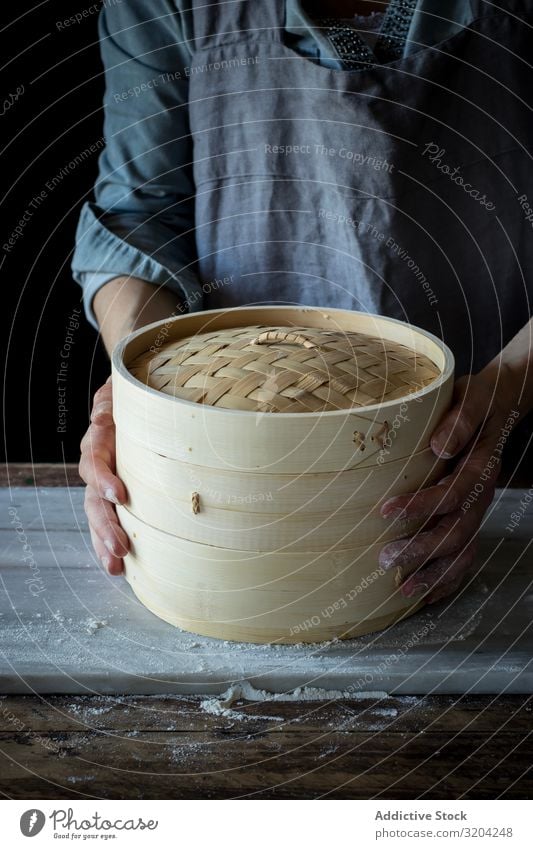 Person holding a bamboo steamer Isolated dim sum kitchenware Container Box Steam utensil Basket oriental Object photography lid Cover Restaurant Cooking