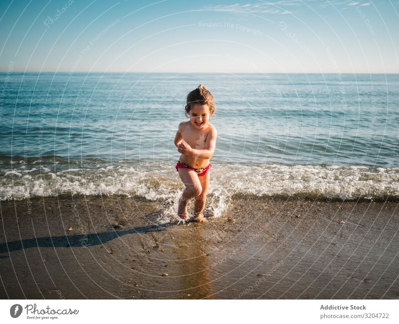 Cheerful girl after bathing in warm sea Girl Swimming & Bathing Ocean Beach Running Child Sand Calm Playing Infancy enjoying Action Joy Summer Toddler