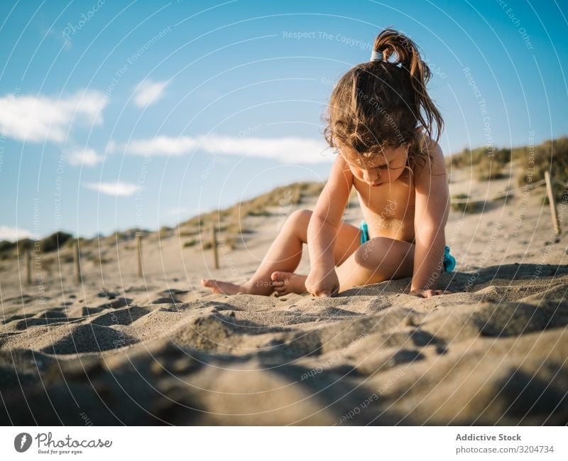 Girl playing on beach in sunny day Beach Playing Sunbeam Day Toddler Sand Delightful seaside Coast Infancy Serene Vacation & Travel Action Sunbathing Child