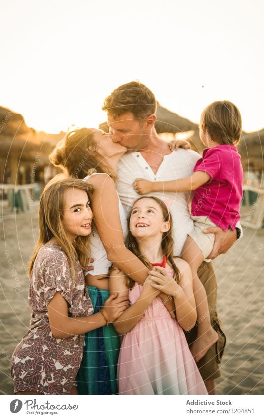 Beautiful happy family with children on beach Family & Relations Parents Love Beach Kissing Happy Child Group sibling Summer Vacation & Travel Embrace Sand