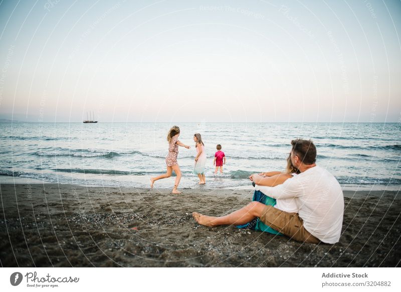 Beautiful happy family with children on beach Family & Relations Love Beach Happy Parents Child Group sibling Summer Vacation & Travel Sit Embrace Sand Playful