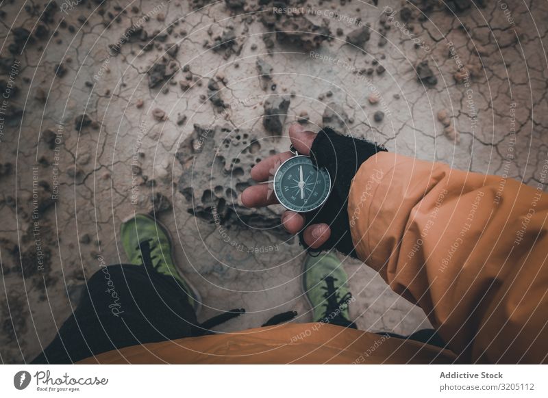 Compass in hand on dry desert area Compass (drafting) Direction Desert Equipment Orientation Sand Adventure Vacation & Travel exploration Geography Magnetic