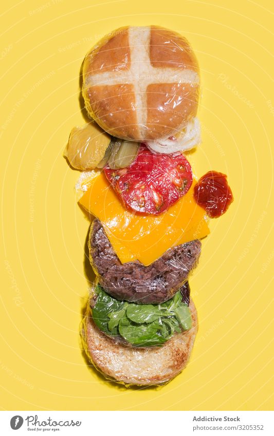 Ingredients of a cheese burger wrapped in plastic Barbecue (event) BBQ Beef Bread Roll Cheese Conceptual design flat lay Food Hamburger Ketchup Lettuce Meat