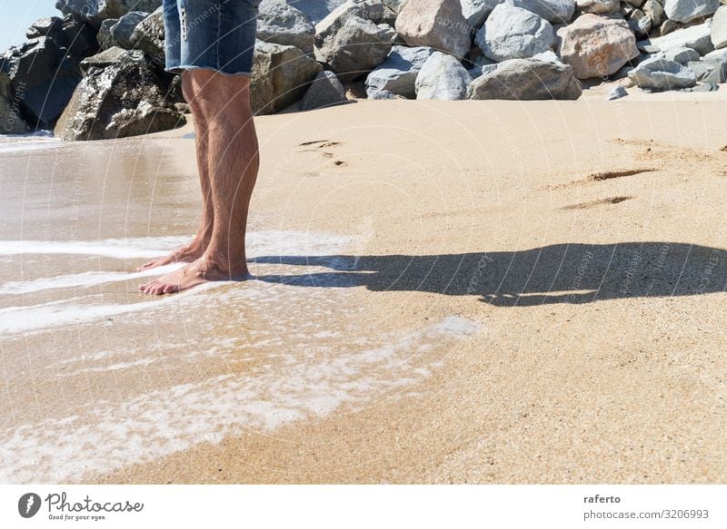 Low angle view of young man standing with bare feet on beach Body Relaxation Freedom Summer Beach Ocean Human being Man Adults Feet Nature Sand Coast Stand Wet