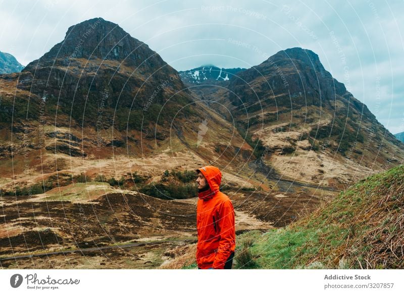 Man standing against picturesque landscape man mountain wind hoodie scotland raining coat nature cold travel view valley beauty freedom male adventure trekking