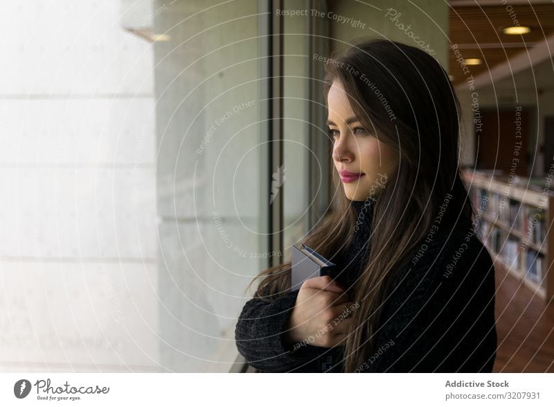 Stylish confident bright woman in glasses leaning on wall and looking at  camera - a Royalty Free Stock Photo from Photocase