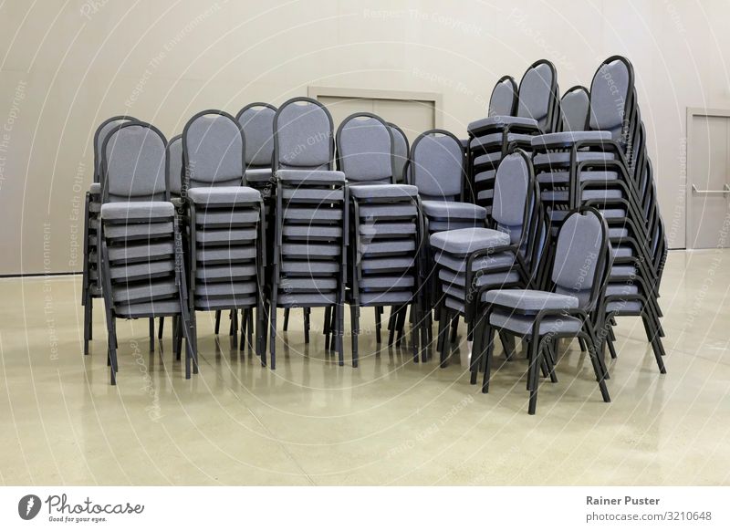 Stacked chairs in the conference hall Office Meeting Conference hall Chair Group of chairs Stack of chairs Steel Stand Modern Gloomy Gray Orderliness