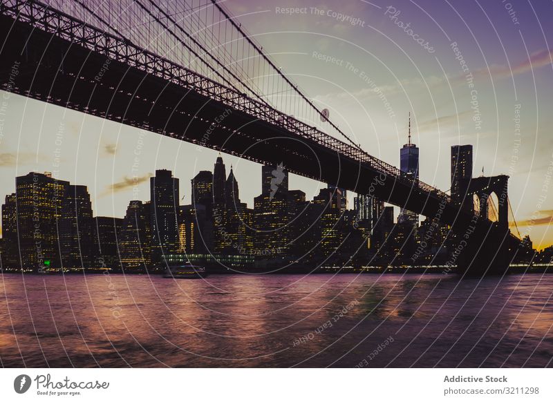 brooklyn bridge at evening with manhattan landscape on background city view illuminated river skyscraper architecture building cityscape travel night modern