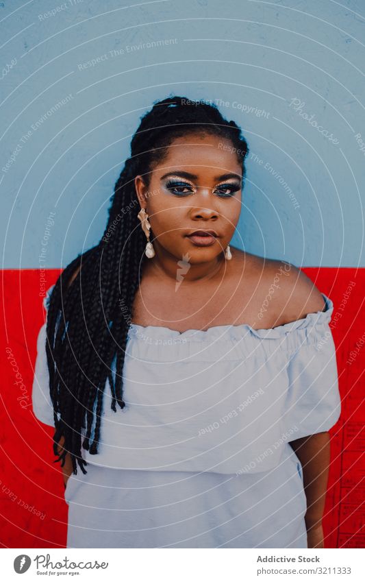 Dreamy trendy African American woman dreamy modern attractive content stand vibrant african american black ethnic city dress long hair curvy casual makeup