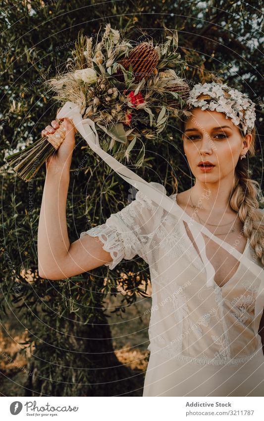 Woman in dress with flower bouquet woman bride boho lace wreath beautiful style tender sensual natural summer romantic wedding blonde hippie nature female hair