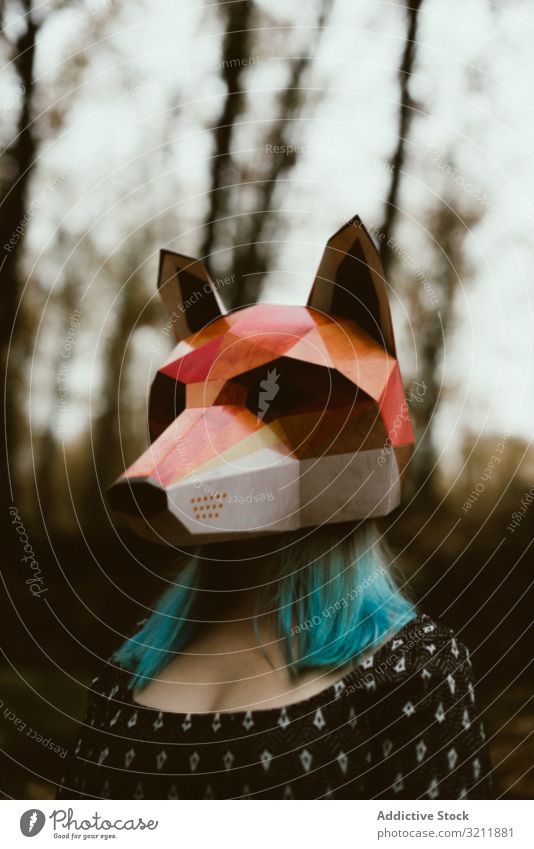 Woman in red fox mask walking in forest woman autumn mysterious overcast wildlife habitat protection endangered female impact fragile loss animal threat