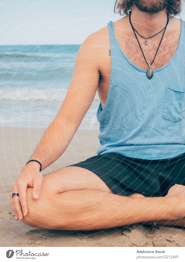 Man training yoga on beach man rest harmony asana exercise seashore energy meditation equilibrium stretch zen relax balance sport lifestyle calm male bearded