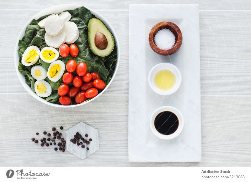 Spinach salad with eggs avocados tomatoes and mozzarella cheese asparagus walnut greenery delicious served food meal gourmet cuisine nutrition dinner spice