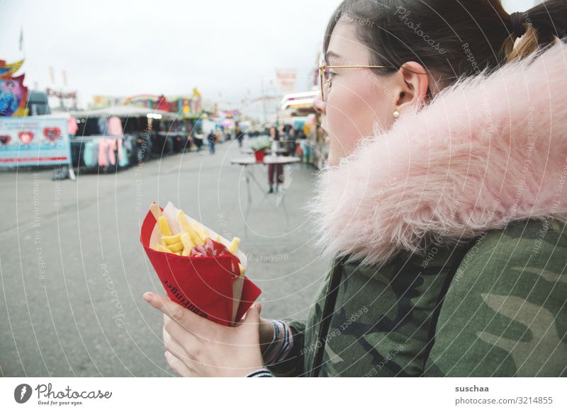 1x french fries with ketchup Young woman Girl Youth (Young adults) teenager winter jacket Fur collar Pink French fries Ketchup Paper bag Hand Street Markets