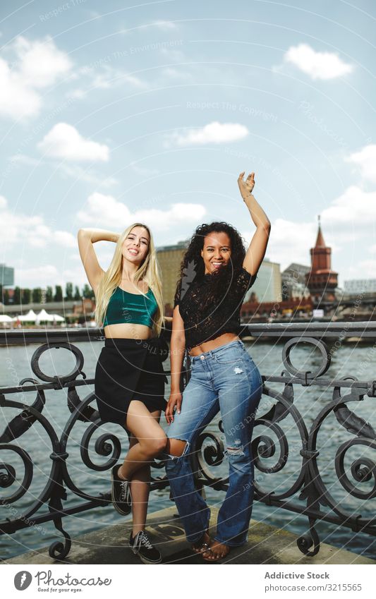 Cheerful friends on city river woman street berlin summer together bonding smile cheerful young happy girlfriend beautiful sunny trendy casual stylish pretty