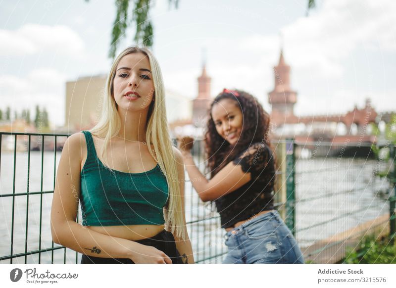 Cheerful friends on city river woman street berlin summer together bonding smile cheerful young happy girlfriend beautiful sunny trendy casual stylish pretty