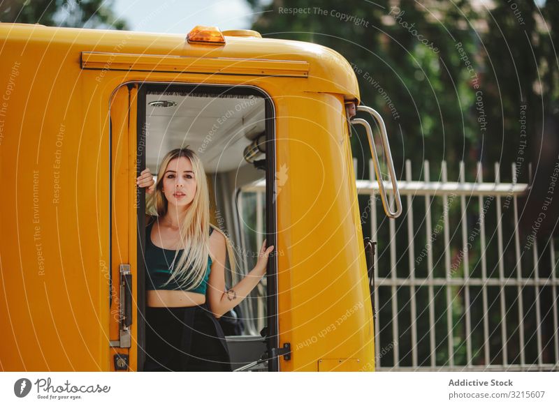 Cheerful blonde woman standing on train in drivers cabin beautiful berlin smile sunny young summer trendy casual journey stylish pretty travel warm relax trip