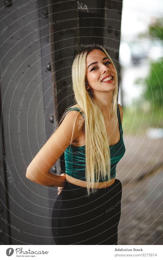 Blonde cheerful model standing and looking at camera woman berlin blonde smile young beautiful fashion stylish slim elegant attractive casual hair female trendy