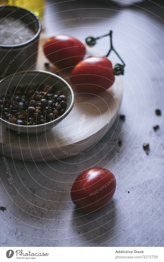 Assorted ingredients on wooden board salad peach onion tomato cherry lettuce cheese pepper slice salt black food spice vegetarian delicious healthy dressing