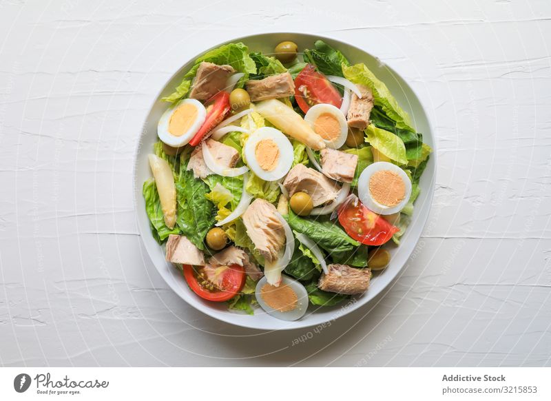 Delicious colorful summer salad tuna lettuce tomato egg olive onion food fish healthy delicious vegetable fresh appetizing bowl green red yellow recipe dish