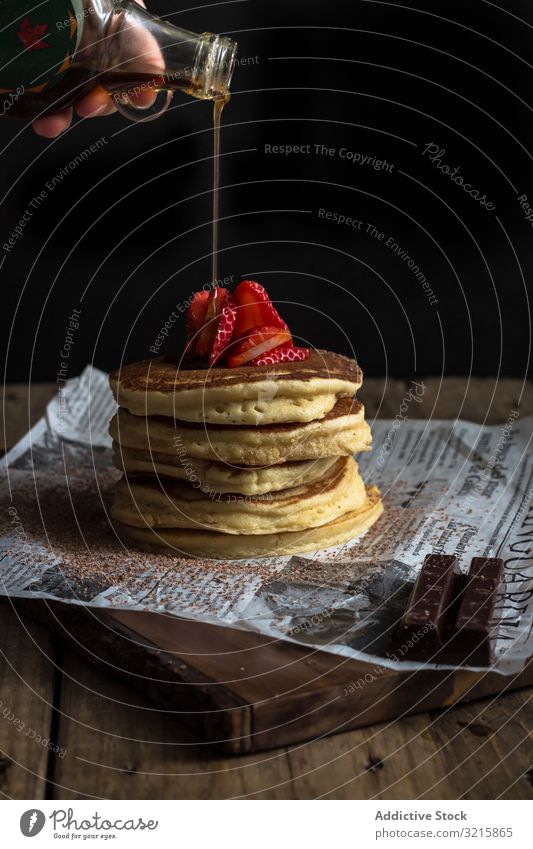 Pancake with strawberries and chocolate covered in syrup pancake strawberry topping breakfast garnish tasty prepare food gourmet sweet meal delicious pour