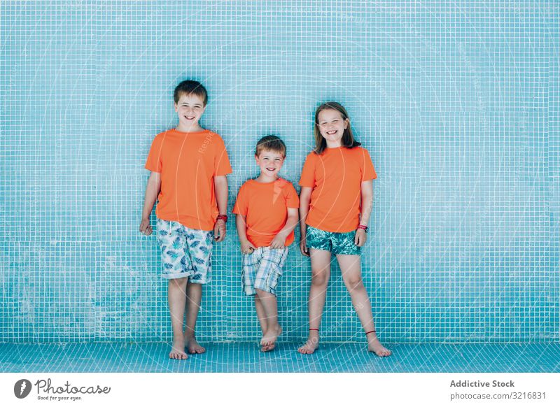 Children standing in empty pool and looking at camera children childhood posing kid smiling summer leisure vacation boy girl brother sister sibling friend
