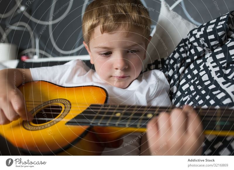 cute boy playing guitar