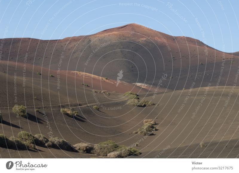 Landscape in Timanfaya National Park. Lanzarote. Canary Islands. Spain. Mountain Nature Sand Hill Peak Volcano Desert Natural arid Canaries desertic dry