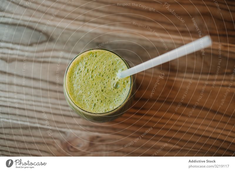 Delicious green smoothie with frothy in glass gourmet homemade kiwi organic nutrition tasty eco food drink exotic tropical blended refreshing sweet overhead raw