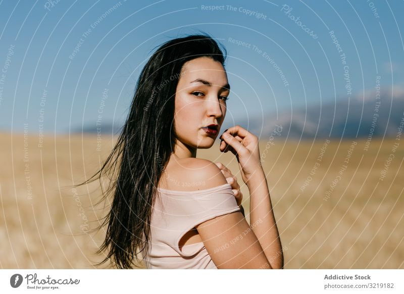 Asian lady standing in field woman windy nature asian weather sensual young summer freedom female meadow grass countryside harmony idyllic calm tranquil serene