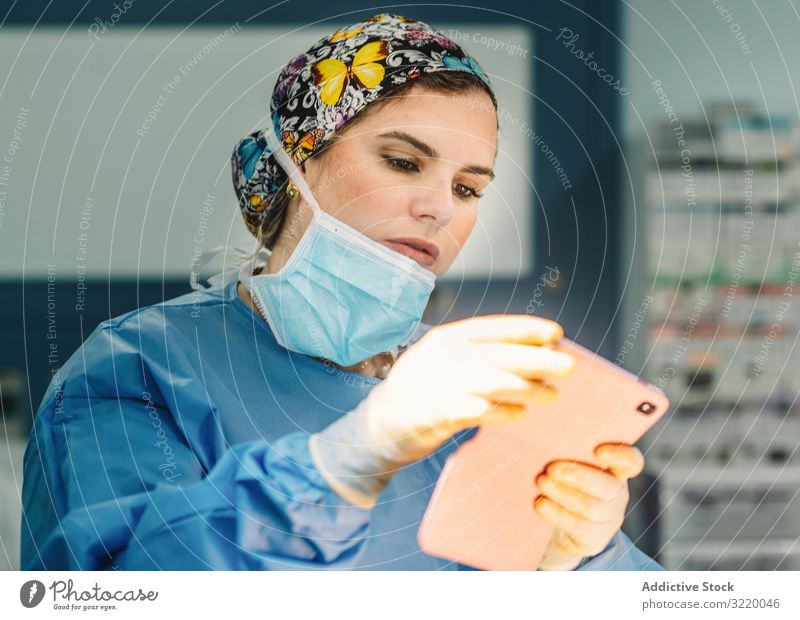 Female doctor standing with smartphone surgeon taking photo woman medicine hospital using operation surgery clinic young female serious beautiful attractive