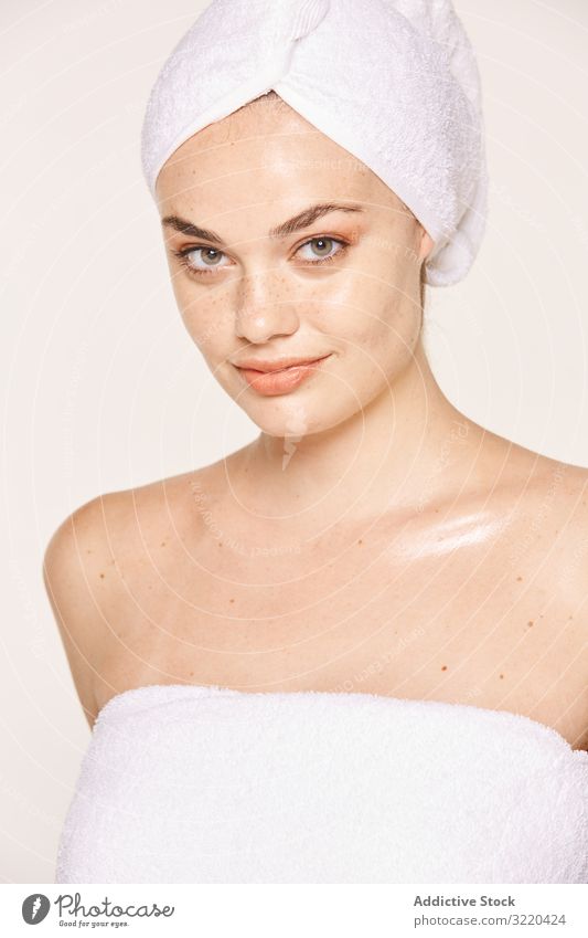 Attractive female with radiant body after cosmetic procedure woman skin face moisturize good-looking attractive pose towel care beauty cream skincare