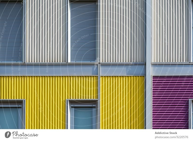 Facade of modern multicolored building with narrow windows exterior colorful architecture facade house property construction investment estate residential