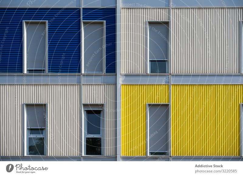 Facade of modern multicolored building with narrow windows exterior colorful architecture facade house property construction investment estate residential