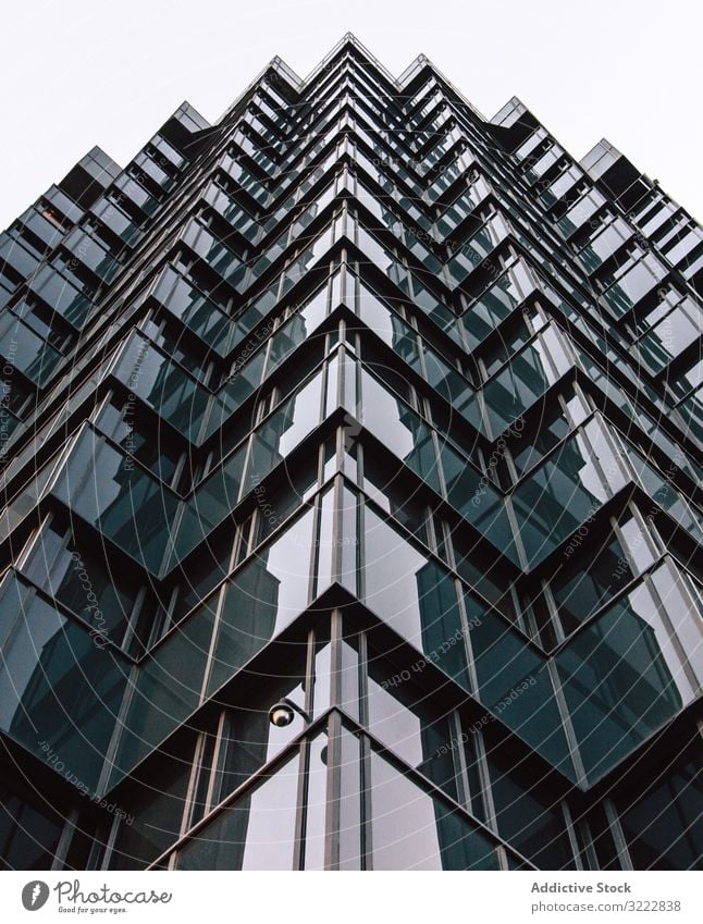 Geometric building of business center with mirrored walls geometric architecture high rise urban construction perspective exterior structure office reflection